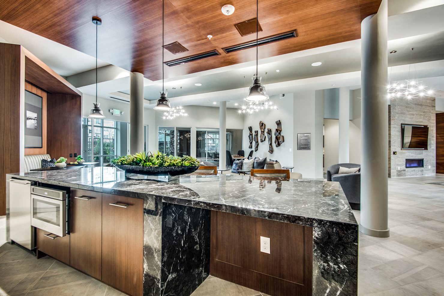 Demonstration kitchen with microwave and mini fridge facing community clubroom