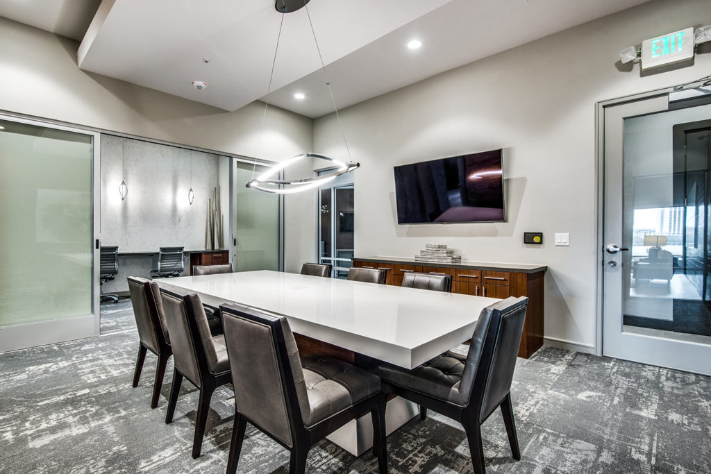 Community conference room with large table and TV screen