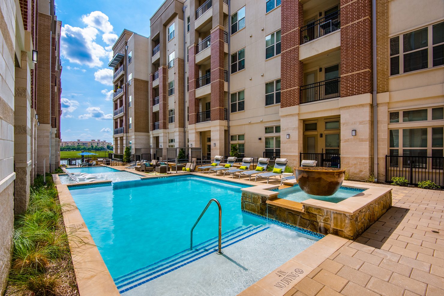 Alternative view of community swimming pool with lounge deck and outdoor seating